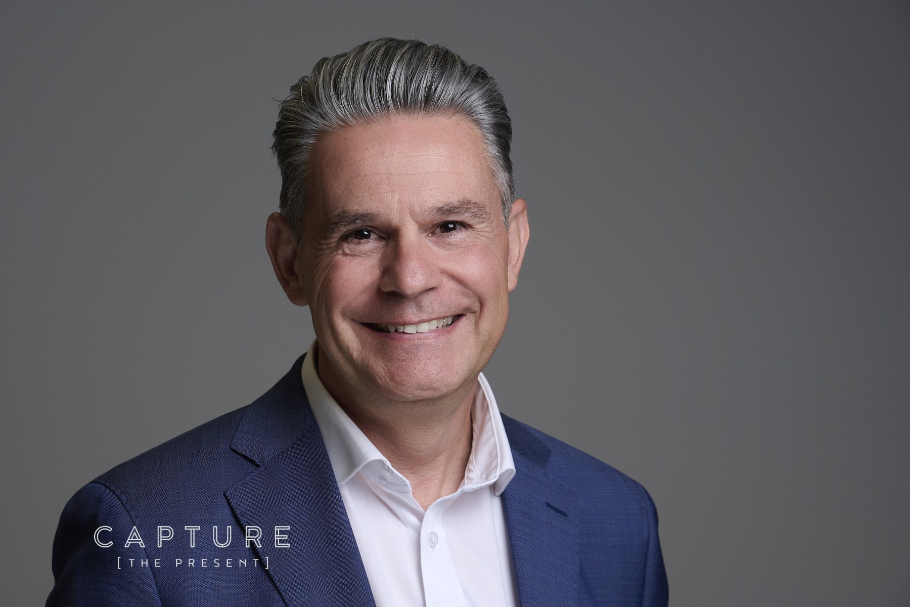 Accountant in a navy blazer smiling in a Brentnalls staff headshot