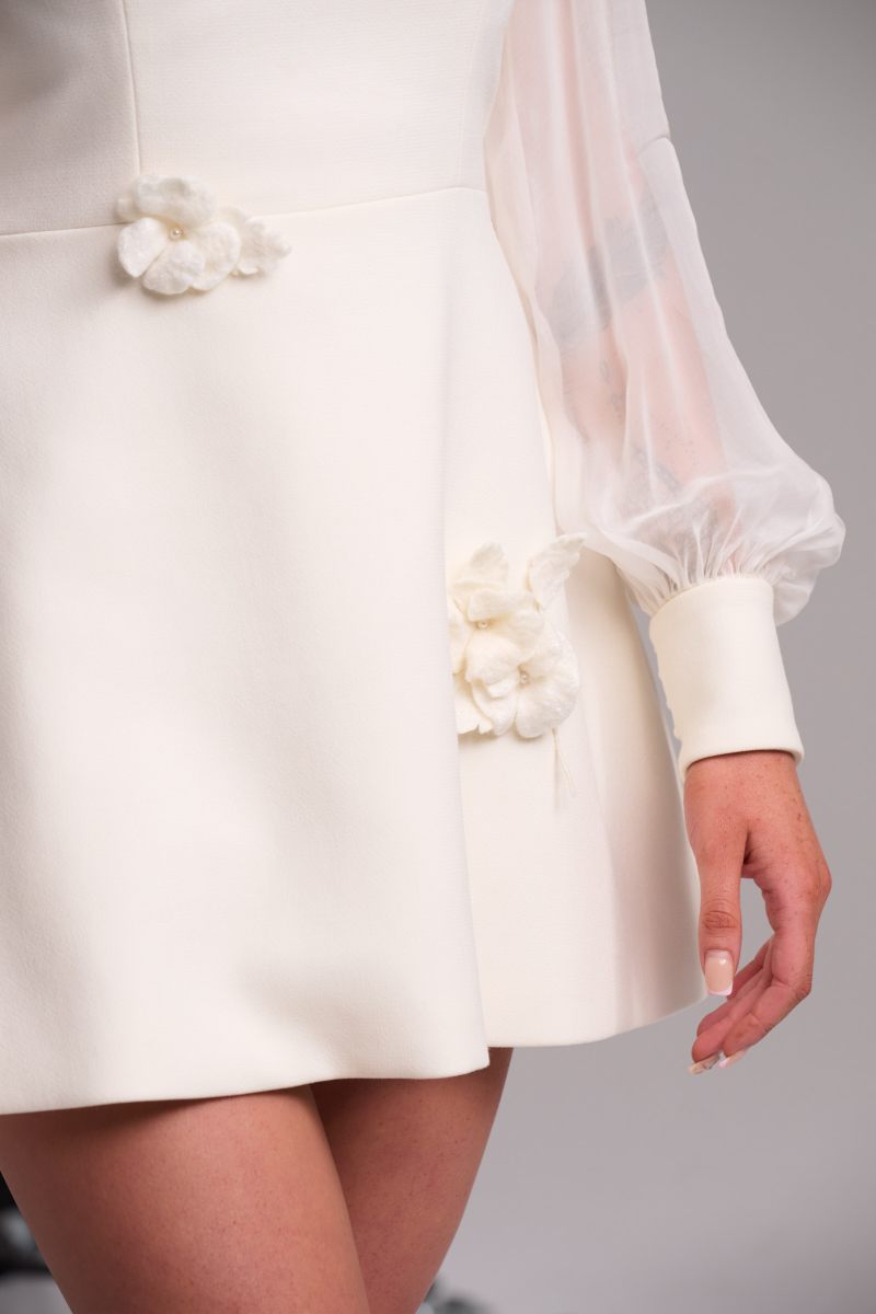 Detail of the Chanel dress cuff and floral appliqué hem in merino wool