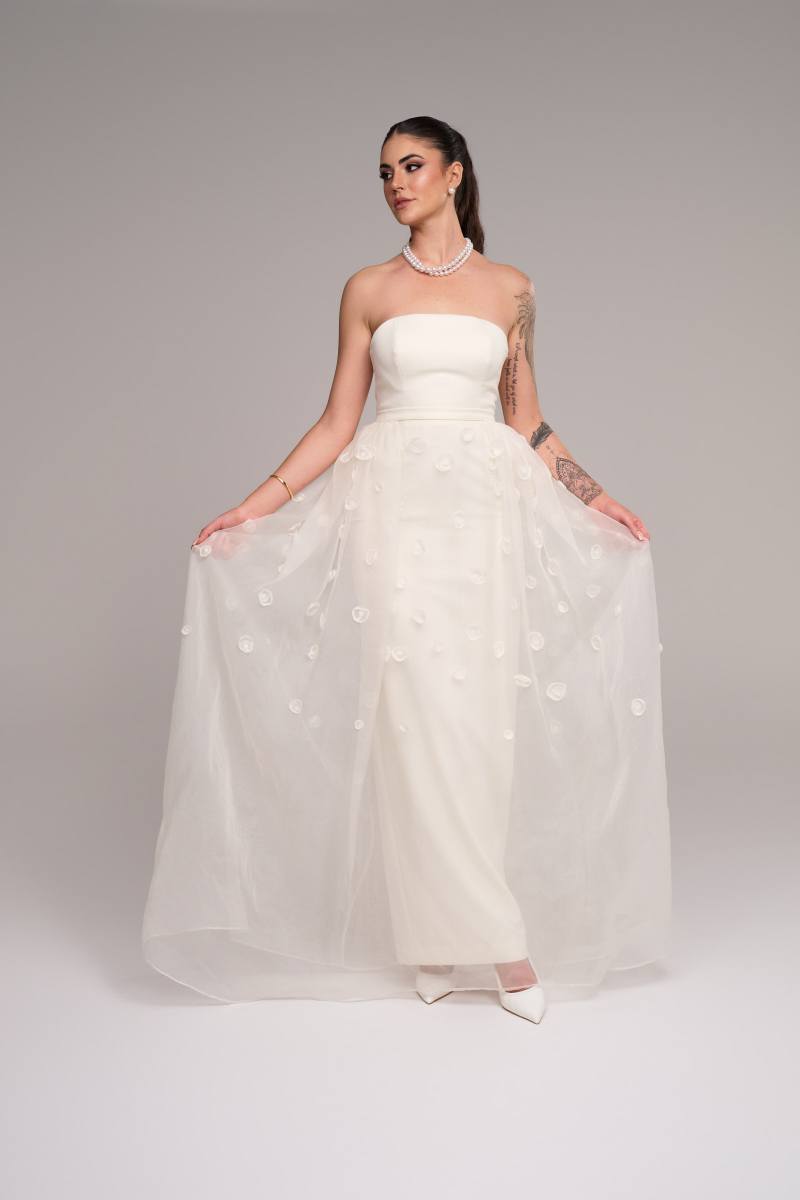 Stevie Hearl wearing the strapless Delta gown with its sheer embroidered overskirt