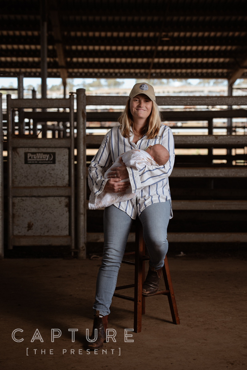 Environmental portrait of a mother and child in the cattle shed at Princess Royal Station