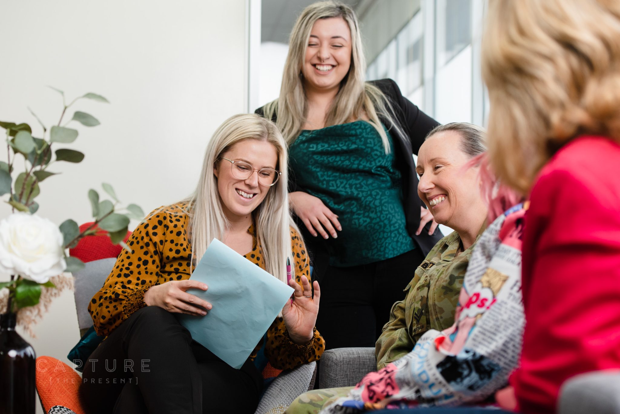 Practice manager Tamika and accountant Nicole laughing with clients at DMC Tax