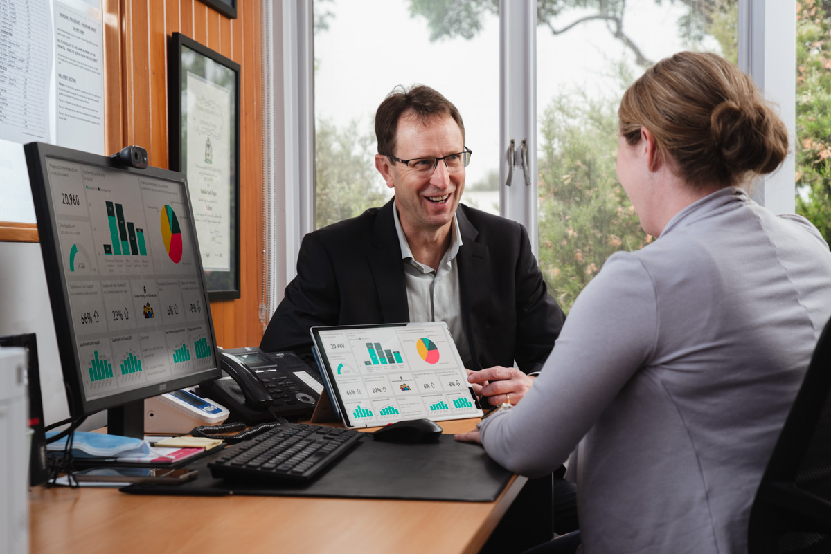 Brentnalls tax accountant advising a doctors clinic owner over a laptop in Adelaide