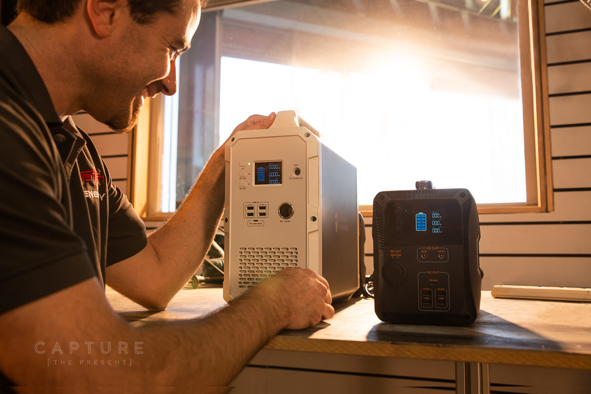 Portable Powertech battery unit being set down on a workbench in window light
