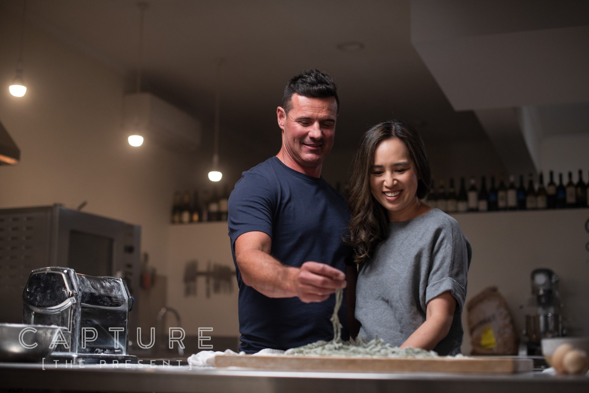 Two people making fresh pasta together in a Barossa Valley kitchen