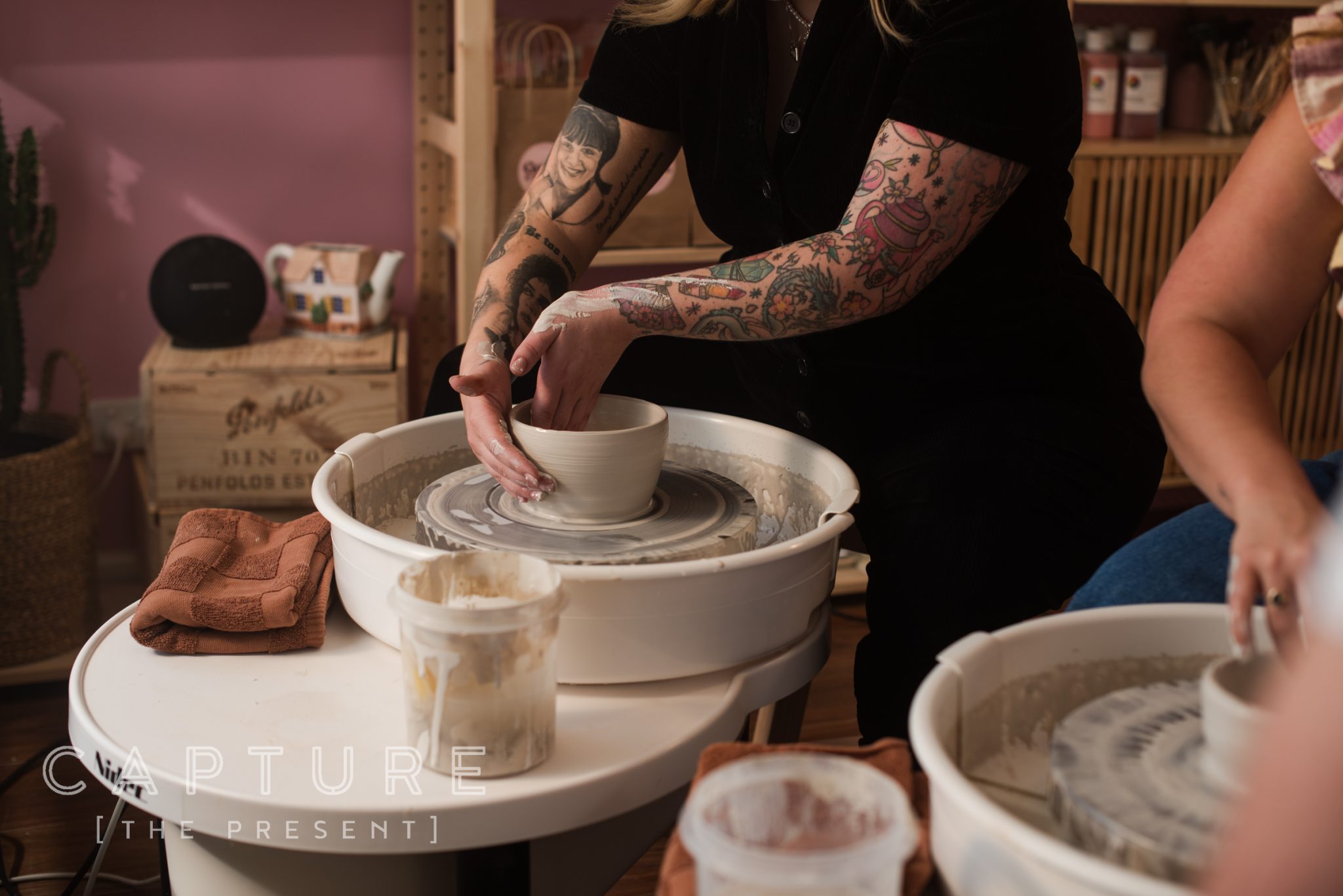 Potter's hands shaping clay on a wheel in a Barossa Valley ceramics studio