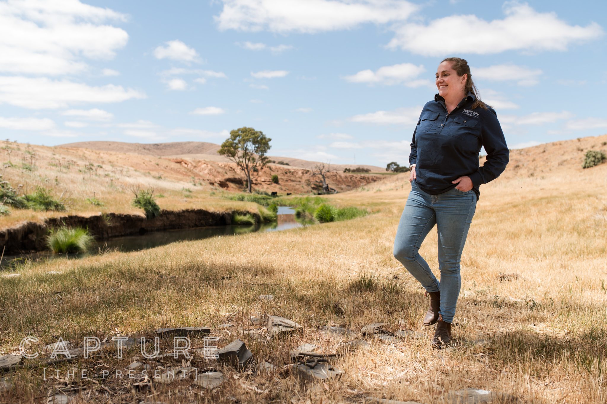 Station worker standing in a dry paddock beside a creek near Burra