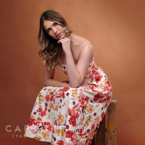 Fashion model in summer dress on brown backdrop